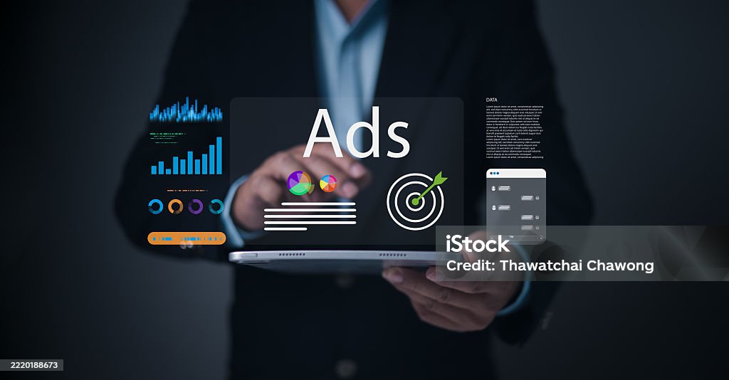 A businessman interacts with a digital tablet displaying targeted ads, colorful marketing graphs, performance analytics, and advertising dashboard UI for digital marketing and online campaign strategy